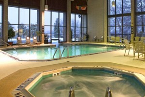 a indoor pool with a hot tub