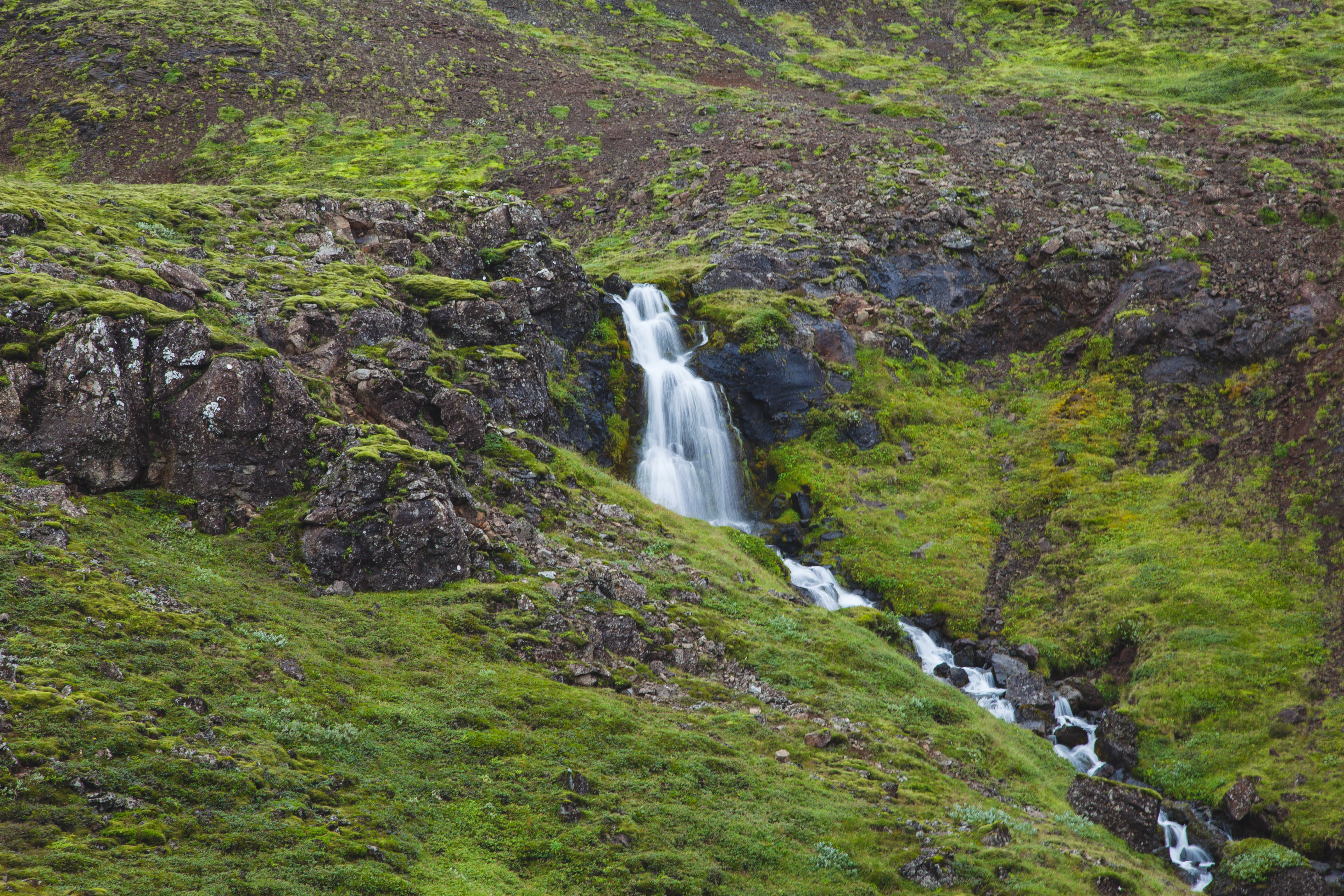 a waterfall on a hill
