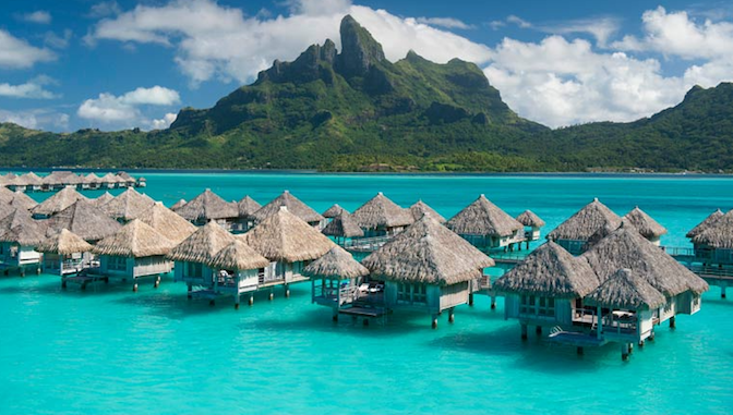 a group of huts in water