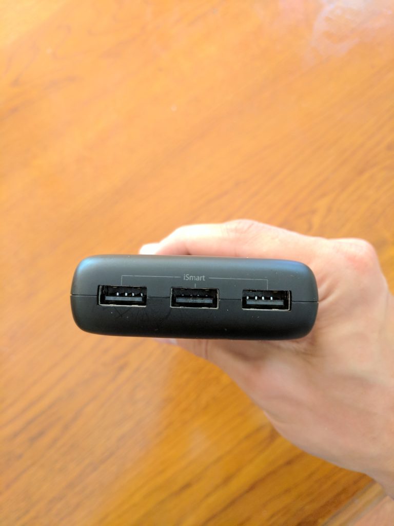 a hand holding a black device
