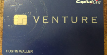 a blue credit card with a gold logo