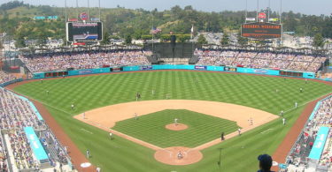 a baseball stadium with people watching with Dodger Stadium in the background