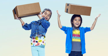 a couple of children holding boxes