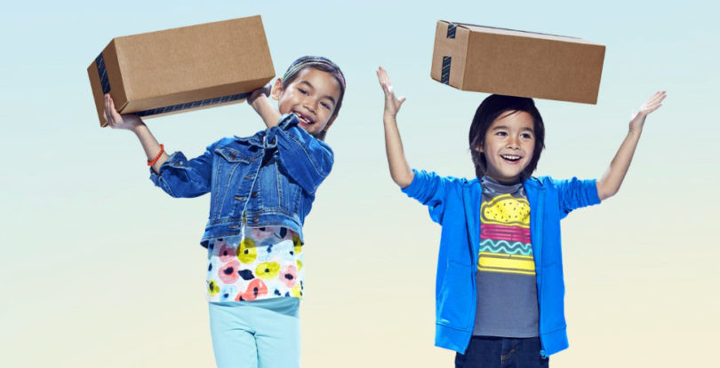a couple of children holding boxes