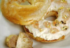a bagel with cream cheese and gold flakes