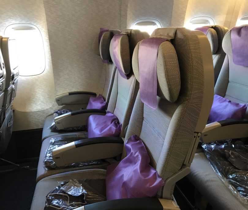 a row of seats with purple pillows