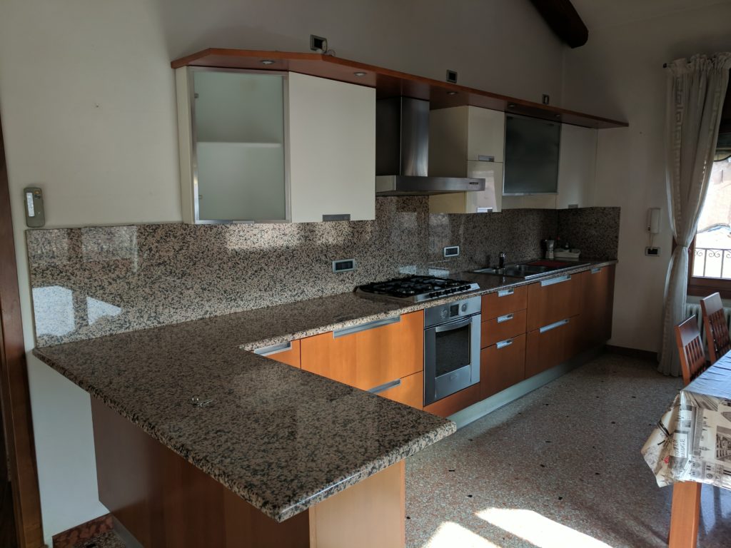 a kitchen with granite counter tops and cabinets