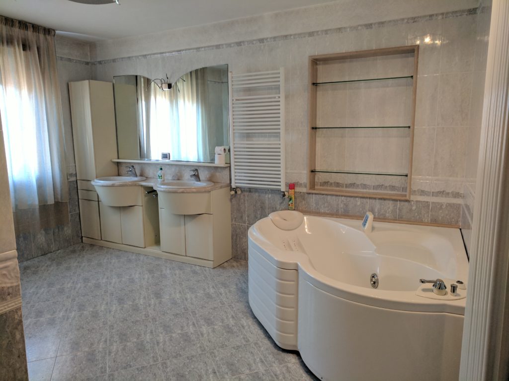 a bathroom with a large tub and sinks