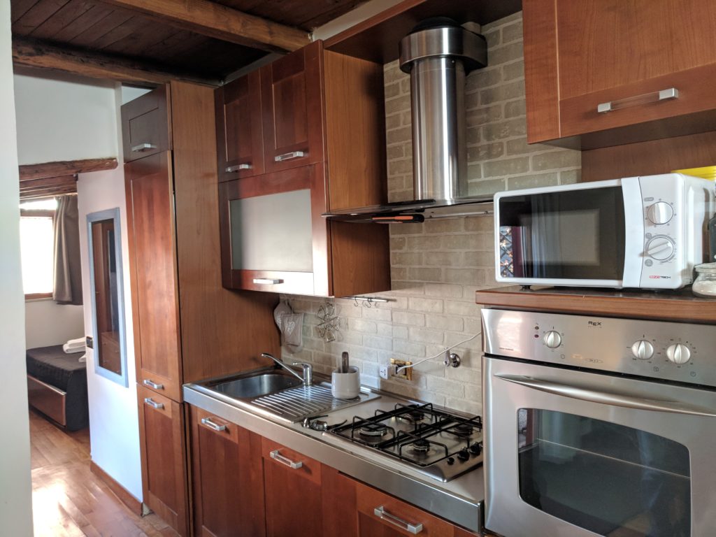 a kitchen with wood cabinets and a stove
