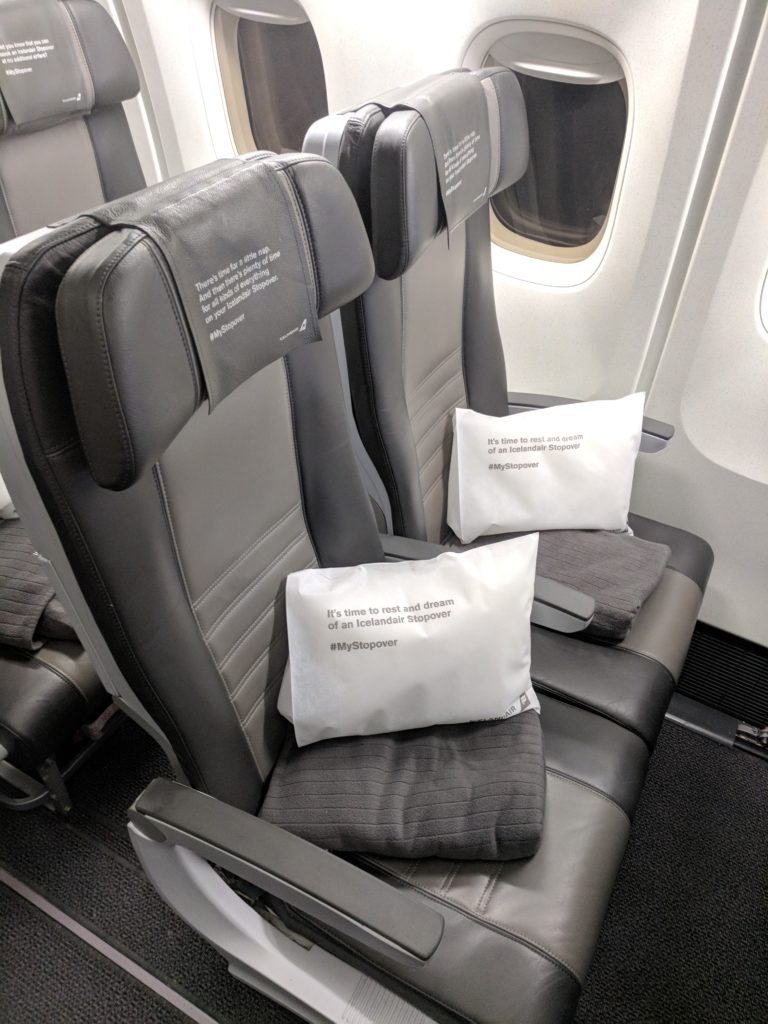 a seat with white pillows on it
