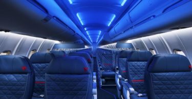 the inside of an airplane with blue lights