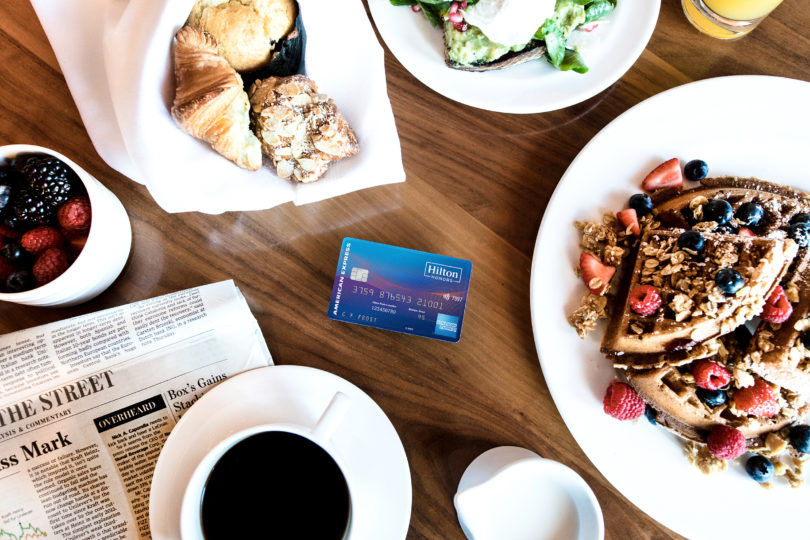 a plate of food and a credit card on a table