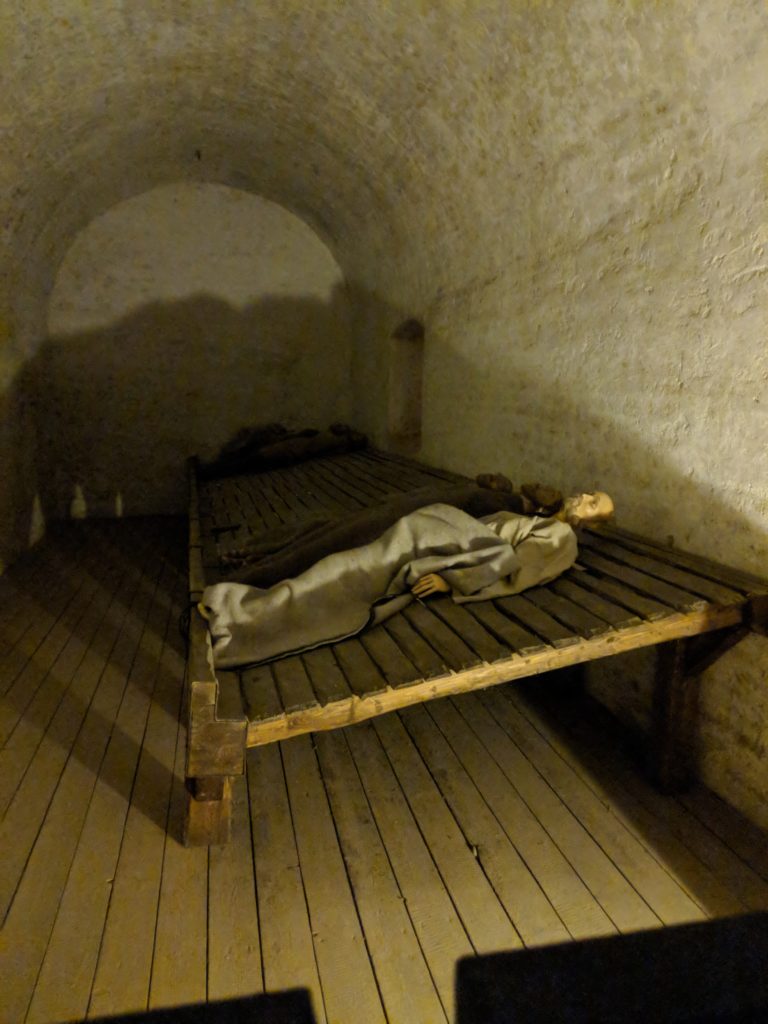 a statue of a man lying on a bed