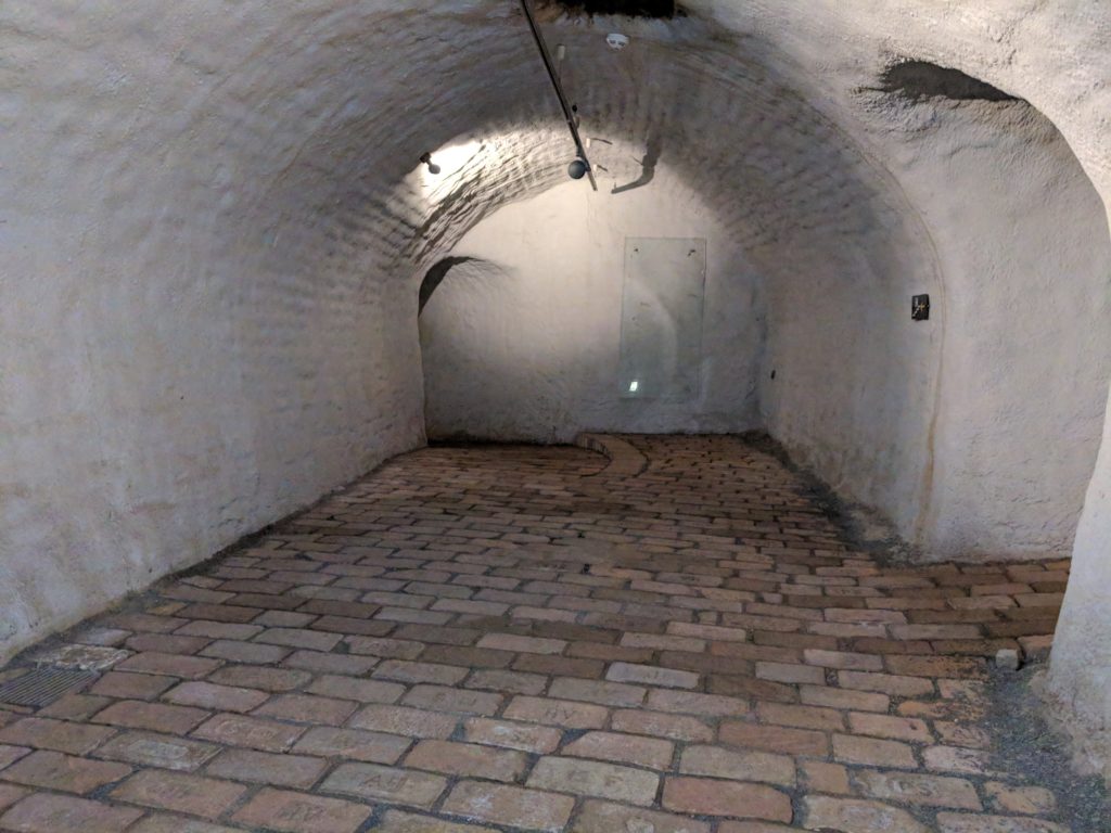 a brick walkway in a tunnel