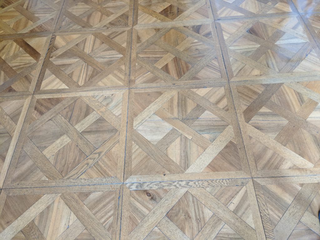 a wood floor with a cross pattern