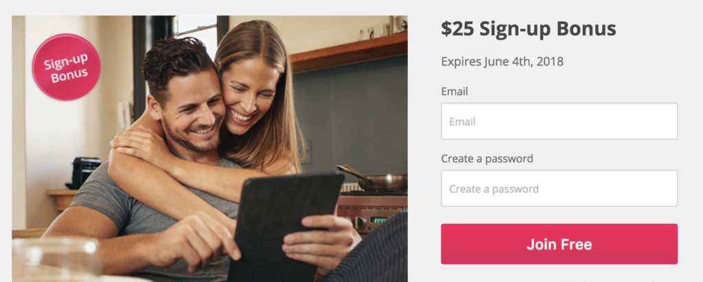 a man and woman hugging and looking at a tablet