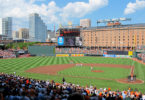 a baseball game in a stadium with Oriole Park at Camden Yards in the background