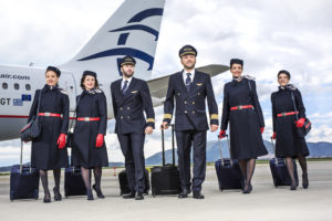 a group of people in uniform with luggage