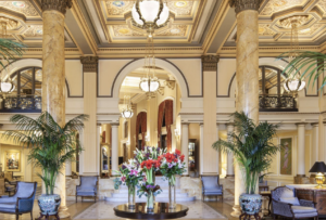 a large lobby with vases of flowers