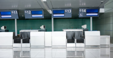 a row of electronic screens in an airport