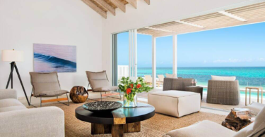a living room with a view of the ocean
