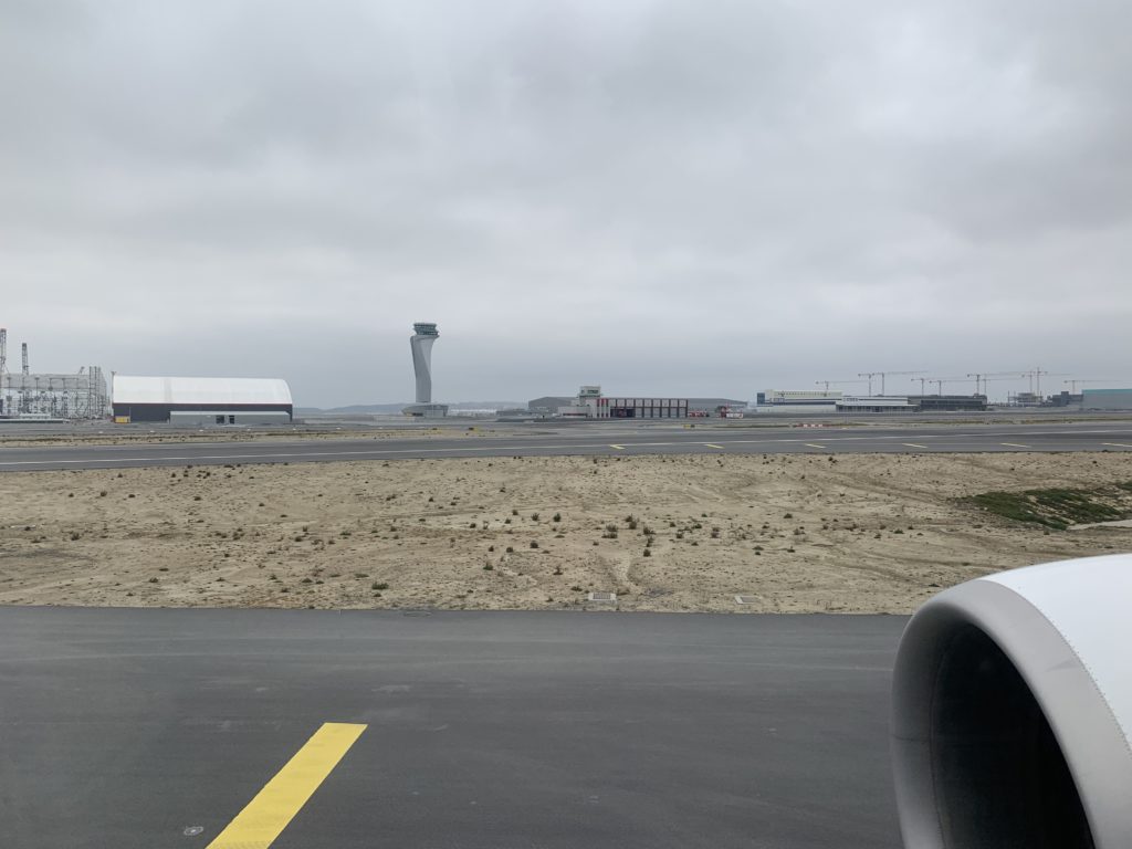 a runway with buildings in the background