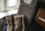 a seat with a striped pillow on the side of it
