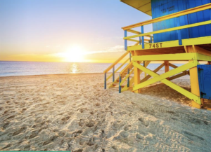 a yellow and blue lifeguard tower on a beach