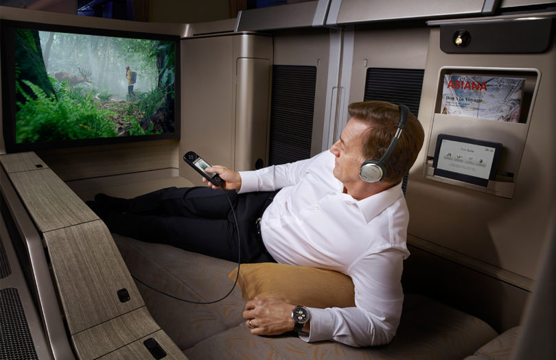 a man sitting on a couch with headphones on