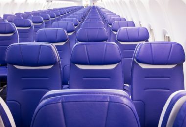 rows of blue seats on an airplane