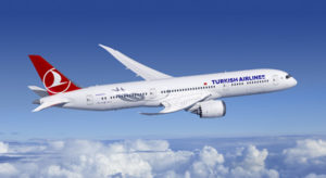 a white airplane flying in the sky