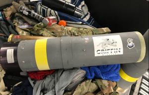 a grey cylinder with a yellow stripe on top of clothes