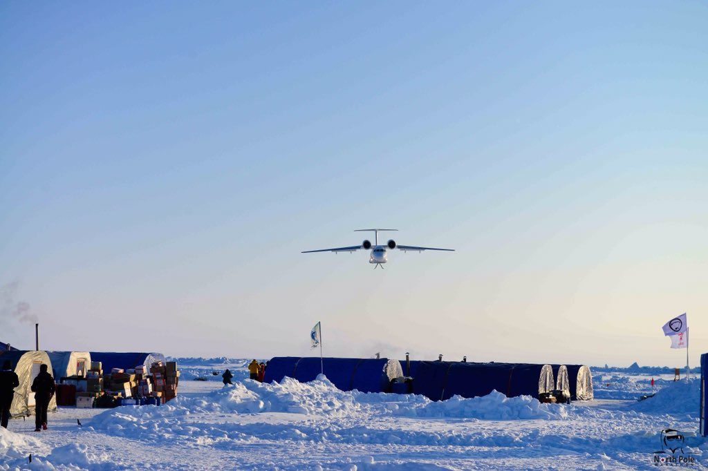 a plane flying over a snowy area