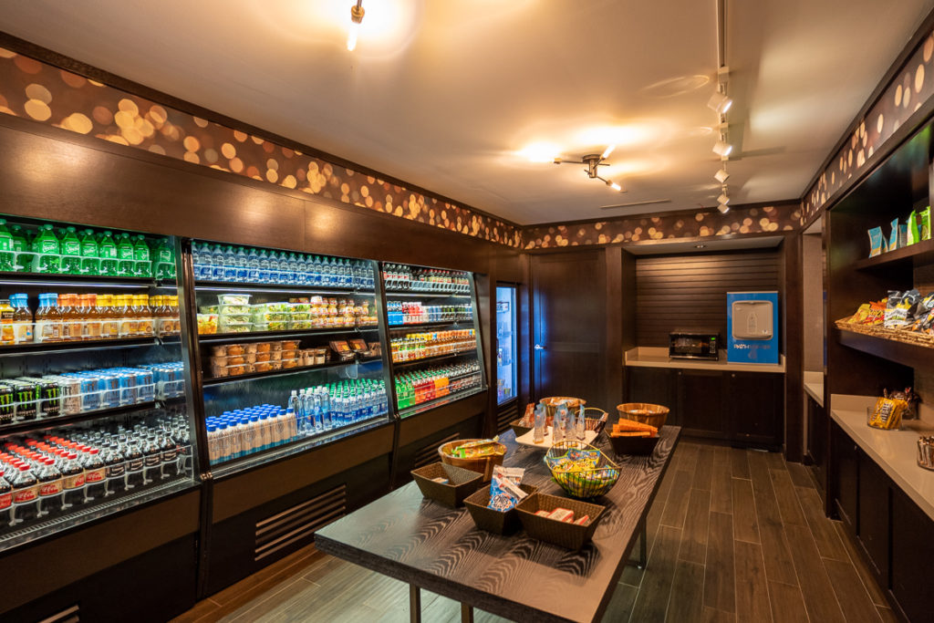 a room with a display case of food and drinks
