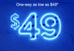 a blue neon sign with dollar signs and white text