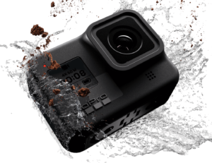 a black camera with water splashing