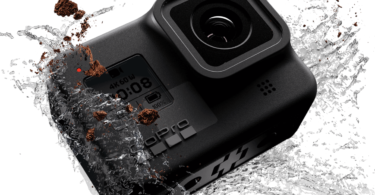 a black camera with water splashing
