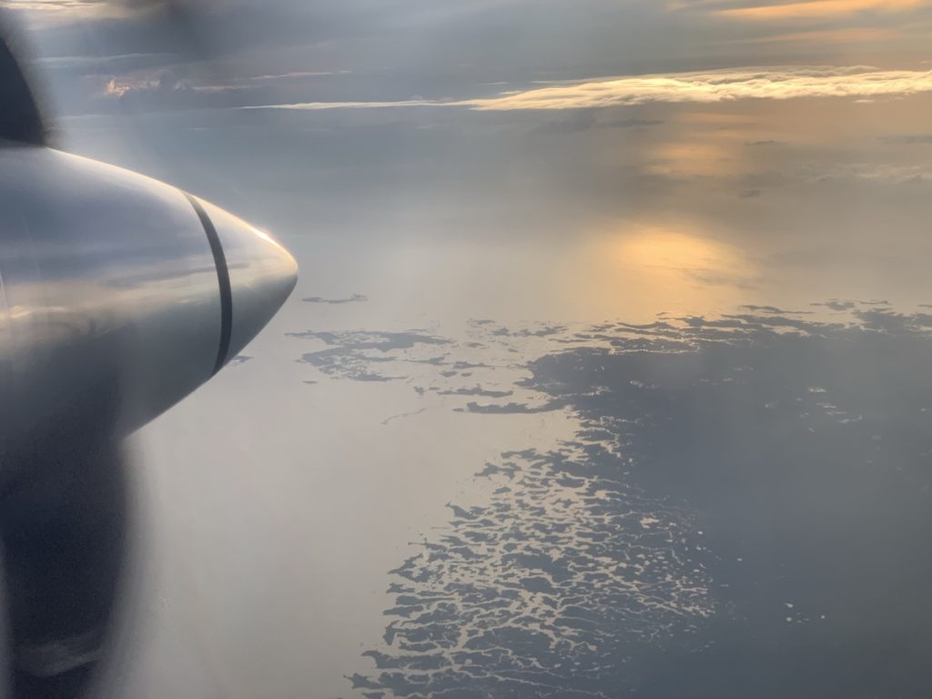 an airplane wing and the ocean