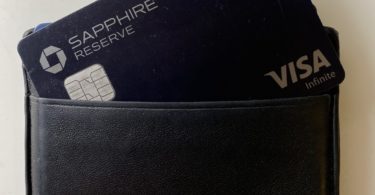 a black wallet with a blue card in it