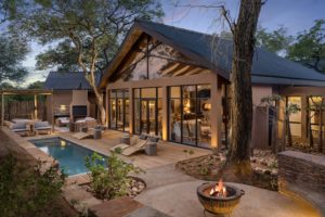 a house with a pool and a fire pit