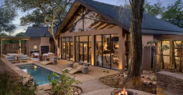 a house with a pool and a fire pit