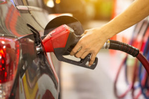 a person pumping gas into a car
