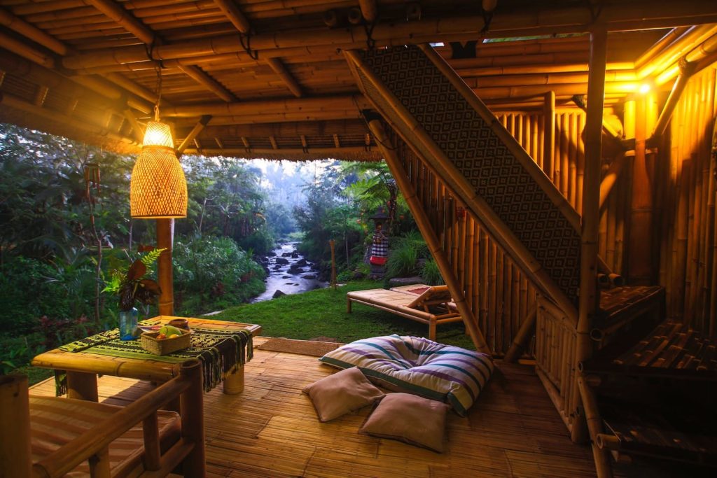 a wooden house with a view of a river and a forest
