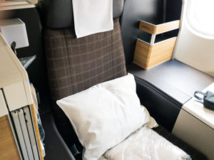 a seat with a pillow and a pillow on it