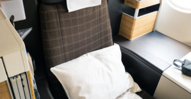a seat with a pillow and a pillow on it