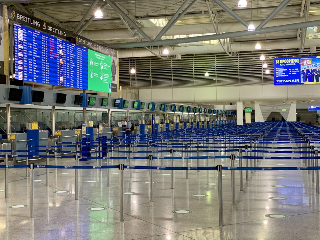 a row of blue barriers in an airport