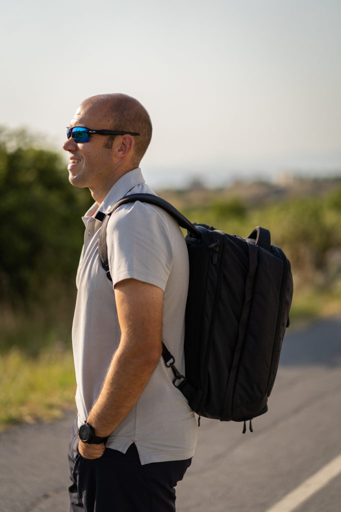 a man wearing sunglasses and backpack