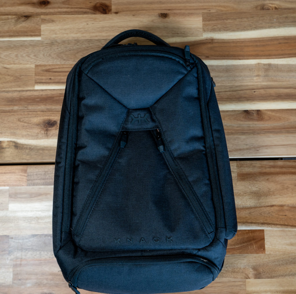 a black backpack on a wood surface