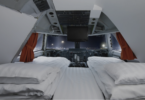 a room with two beds and a television in the cockpit