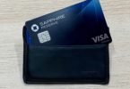 a black wallet with a blue card inside